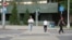 Kazakhstan - a woman crossing street. Astana, 17 July 2023