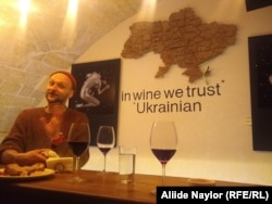 Yevhen Safonov sips wine behind the counter of the MyWine bar in Odesa.