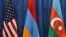 U.S., Armenian and Azerbaijani flags are displayed during peace talks.