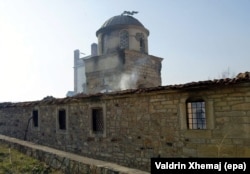 The smouldering remains of the Church of St. Nicholas in Pristina as photographed in March 2004