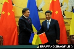 Relațiile dintre China și Ucraina erau călduroase înaintea invaziei Crimeei, care a deschis problema integrității teritoriale, un punct sensibil pentru China din pricina Taiwanului. În imagine: Xi Jinping cu fostul președinte ucrainean pro-rus Viktor Ianukovici, în 2013.