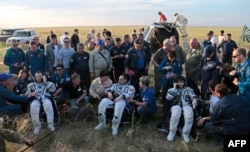 Tatarstan. Comandantul Expediției 43, Terry Virts, de la NASA, cosmonautul Anton Șkaplerov de la Agenția Spațială Federală Rusă (Roscosmos) și astronautul italian Samantha Cristoforetti de la Agenția Spațială Europeană (ESA) stau pe scaune în afara spațiului Soyuz TMA-15M.