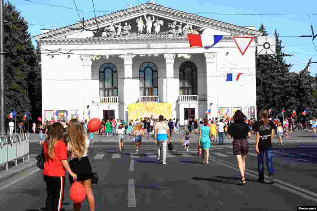 Mariupol locals walking in front of the&nbsp;Donetsk Regional Drama Theater during a French-themed festival in 2019.&nbsp;