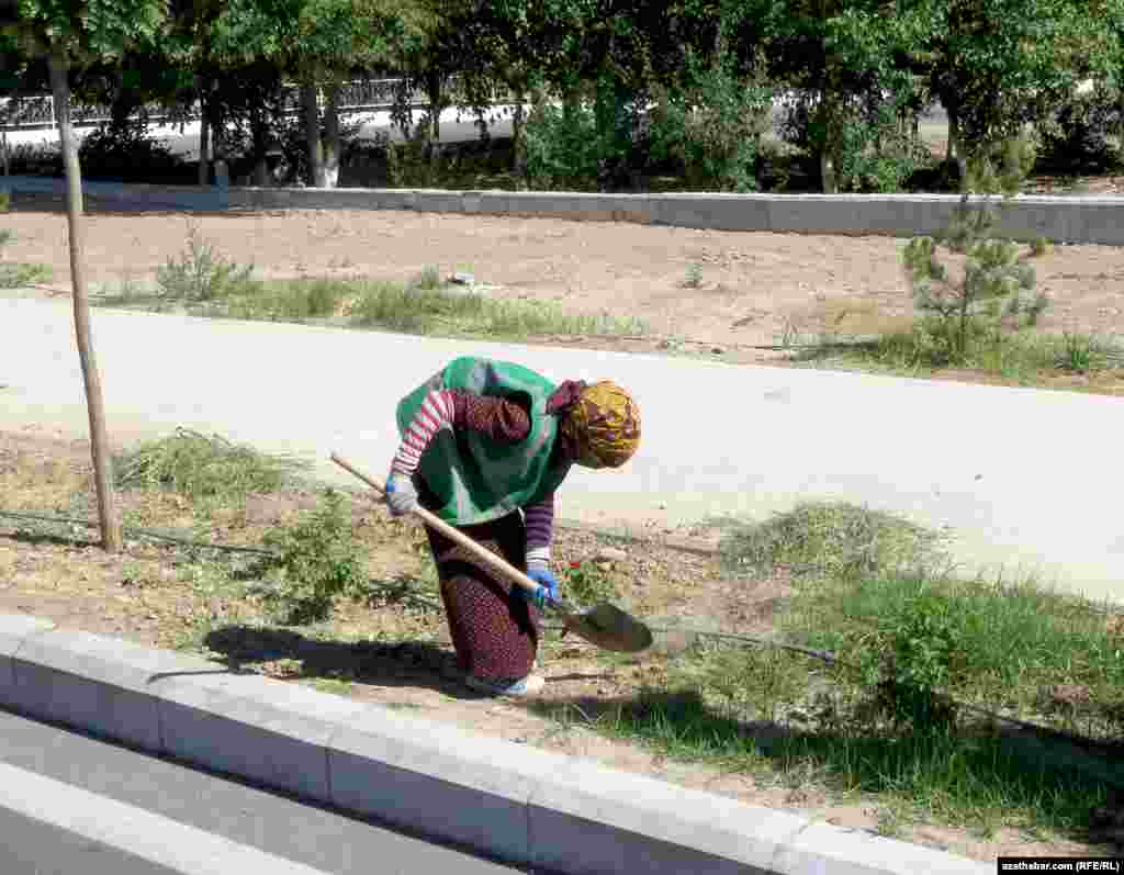 Köçede iş geçirip ýören işçi zenan