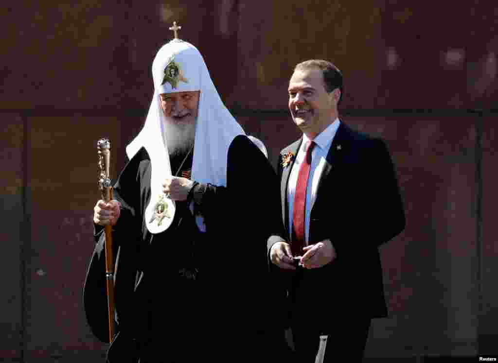 The deputy Head of the Russian Security Council, former President Dmitry Medvedev, and Patriarch Kirill of Moscow and All Russia attend the Victory Day parade.