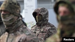 Soldații ruși care se pregătesc să fie detașați în Ucraina participă la o ceremonie de recepție a noilor vehicule în septembrie 2025.