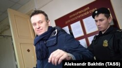 Aleksei Navalny is escorted to a court in Kirov on January 31.