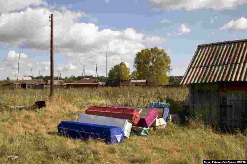 A pile of coffins at the ready. Families usually bury their dead by noon of the day following their death. "People don't know what to eat and how to survive," Ismagilova says. "They have been left here to die as guinea pigs."