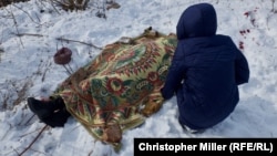 Nadia Volkova leans over the body of her mother, Katya, who was killed during shelling in the eastern Ukrainian city of Avdiyivka on February 1.