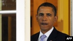 U.S. President Barack Obama walks out of the Oval office on September 14