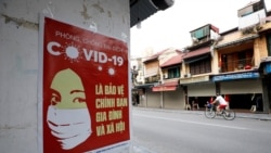 Баш калаа Ханой шаарындагы коронавирустун кооптуулугу жазылган көрнөк.