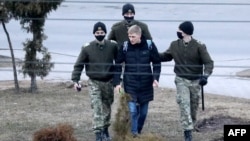 A man is detained in Minsk on March 25, one of at least 170 detained in the capital.