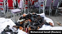 he shoes of victims are seen outside a damaged wedding hall after a blast in Kabul on August 18.