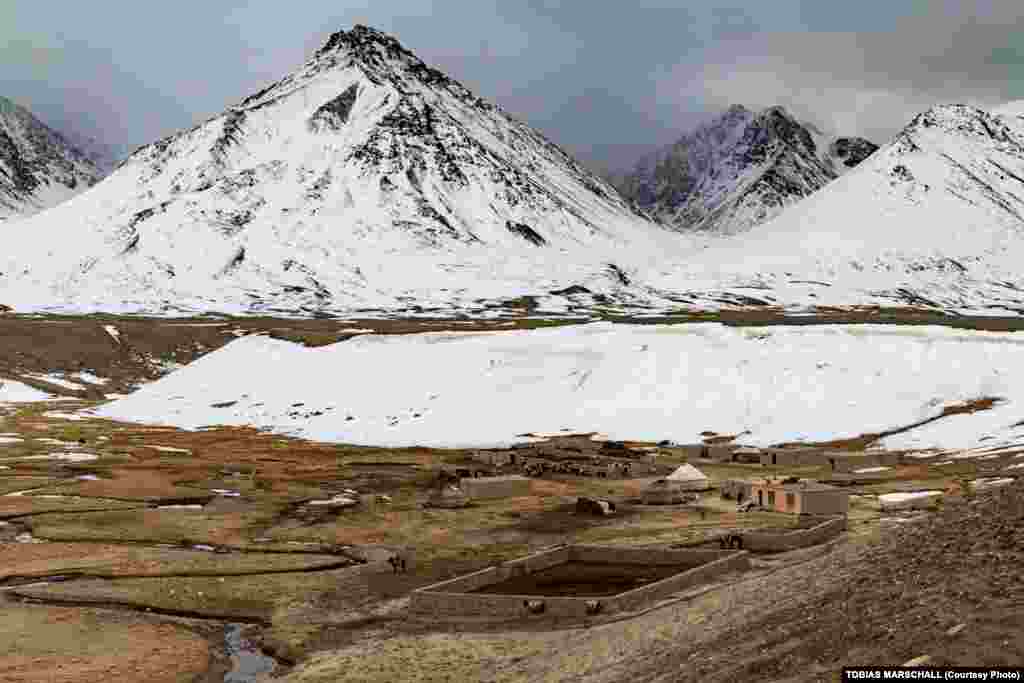 Mud-brick houses at a winter settlement provide some respite from the strong wind, while the stone walls of a corral protect livestock from predators during the night. 