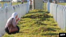 A Bosnian Muslim woman and survivor of the Srebrenica massacre, mourns near graves of her relatives at a memorial cemetery in eastern Bosnia. (file photo)