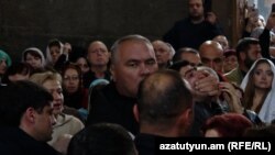 Armenia - A security officer shuts a protester's mouth during a ceremony at Hovanavank monastery, October 26, 2025.