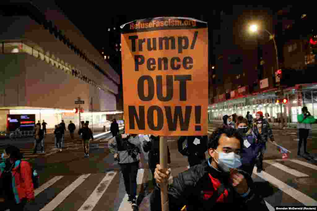A protester holds a placard during a march against U.S President Donald Trump's administration on Election Day in New York City, New York, U.S. November 3, 2020.&nbsp;