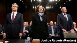 FBI Director Christopher Wray (left to right), CIA Director Gina Haspel, and Director of National Intelligence Dan Coats arrive with other U.S. intelligence community officials to testify before a Senate Intelligence Committee hearing in Washington on January 29.