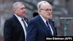 Rudy Giuliani (center) and Soviet-born businessman Lev Parnas arrive at the National Cathedral in Washington on December 5, 2018.