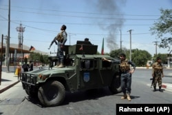 Afghan security forces arrive at the scene of the explosion in Kabul on July 1.