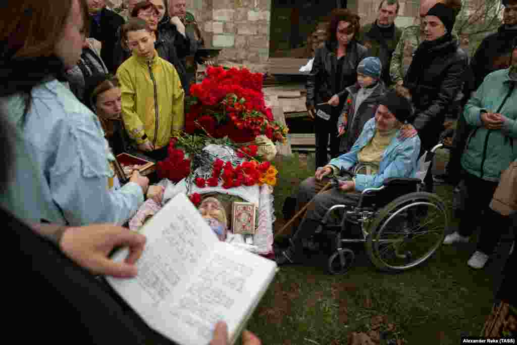 The mother (in wheelchair) of Mikhail Kishchik looks at her son's body during his funeral in an area of Ukraine's Luhansk region held by Kremlin-backed separatists.&nbsp;Kishchik was described as a lieutenant colonel within the separatist militia. &nbsp;