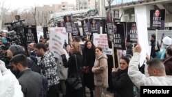 Armenia - People hold pictures of Armenian prisoners in Azerbaijan during a protest outside the Red Cross office in Yerevan, March 3, 2025.