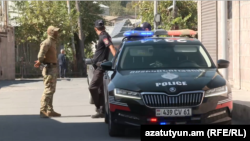 Armenia - Police officers are seen near the scene of a deadly shooting in the village of Merdzavan, September 24, 2025.