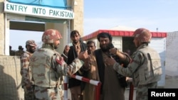 Pakistani soldiers check the identity of citizens returning from Afghanistan at the border crossing in Chaman on March 7.