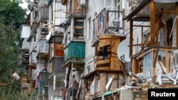 Aftermath of a Russian missile and drone attack in Kyiv that killed 31 people, including five children.