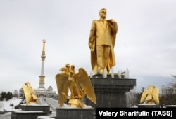 When tourists in Ashgabat visit the sites, such as this monument to the late Turkmen President Saparmurat Niyazov, they must be accompanied by an official tour guide "at all times."