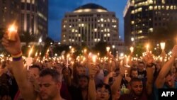 Орландадагы Pulse түнкү клубунда курман болгондорду адамдар колуна шам кармап эскерүүдө. 13-июнь, 2016-жыл