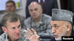 General Stanley McChrystal listens to Afghan President Hamid Karzai in Kabul. Karzai said that the general had cultivated public trust in Afghanistan.