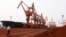 Soil containing various rare-earth elements waits to be loaded on to a ship at a port in Lianyungang, China. (File photo)