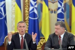 Ukrainian President Petro Poroshenko (right) listens to NATO Secretary-General Jens Stoltenberg during a National Security and Defense Council meeting in Kyiv.