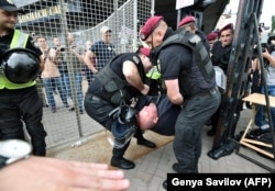 Police detain an activist during a protest against a gay-pride march in central Kyiv on June 17.