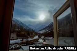 Кыргызстандагы тоо койнунда жайгашкан кыштактардын бири. Терезеден көрүнүп турган ак карлуу тоолор.