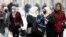 Women wearing face masks walk on the street in Sarajevo last month. By December 11, there were 99,543 confirmed infections and 3,250 COVID-19 deaths in the country of 3.4 million..