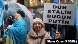 A woman holds a sign reading, "Yesterday Stalin, Today Putin" at a protest in Istanbul against Russian actions in Crimea.