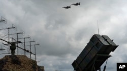 Cистема протиповітряної оборони Patriot на землі й літаки F-16 у небі, фото ілюстративне