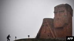 Nagorno-Karabakh - A man walks towards the statue "We Are Our Mountains" outside Stepanakert on November 12, 2020.