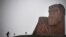 Nagorno-Karabakh - A man walks towards the statue "We Are Our Mountains" outside Stepanakert on November 12, 2020.