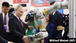 Russian President Vladimir Putin visits an exhibition at the Harbin Institute of Technology in Harbin as part of a 2024 state visit to China. 