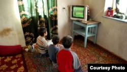 Теле сабак көрүп жаткан окуучулар.