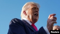 US President Donald Trump speaks with the media at Joint Base Andrews.