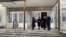 Reprezentanți ai guvernului, la intrarea în clădirea liceului „Evrika” din orașul Râbnița, preluată forțat de autoritățile separatiste în 2004. Vizita a avut loc în decembrie 2021.