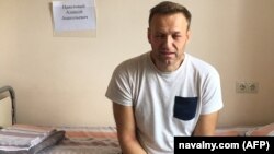 A handout image made available on the official website of Aleksei Navalny shows the opposition leader sitting on a hospital bed in Moscow on July 29.