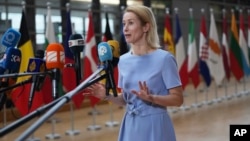 European Union foreign policy chief Kaja Kallas speaks with the media as she arrives for a meeting of EU foreign ministers on June 23.