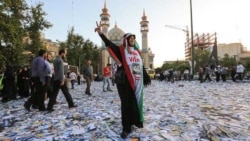 A woman shows a victory sign after a campaign rally in early June.