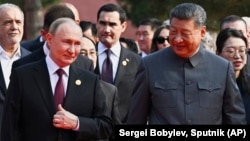 Russian President Vladimir Putin and Chinese President Xi Jinping arrive at a military parade in Beijing on September 3.