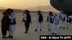 "Талибандын" саясий кеңсесинин башчысы Абдул Гани Барадар баштаган топтун Ооганстанга барган учуру. 17-август, 2021-жыл.  Талибдерге таандык телеканал тарткан видеодон алынган сүрөт.